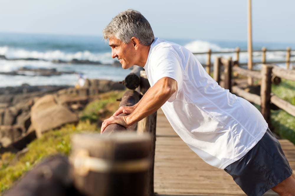 Fit-senior-man-exercising-at-the-beach