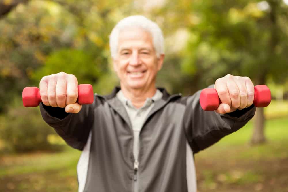 Senior-man-lifting-light-weights-in-the-park