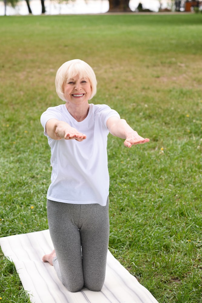 Senior-woman-on-knees-performing-balance-exercise