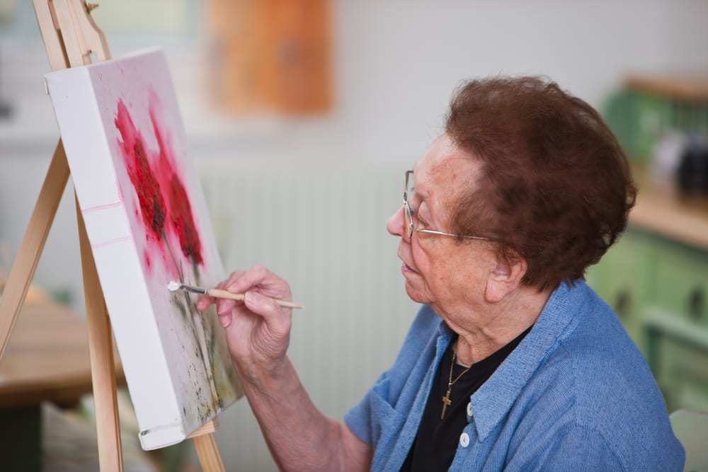 senior-woman-painting-on-a-canvas