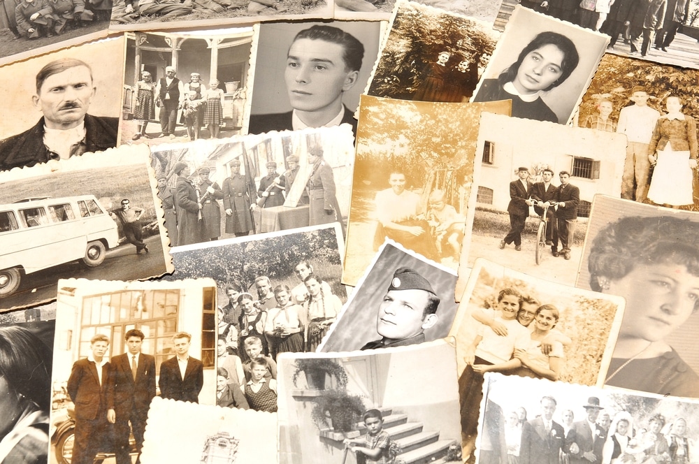 Array of old photographs spread out on a surface