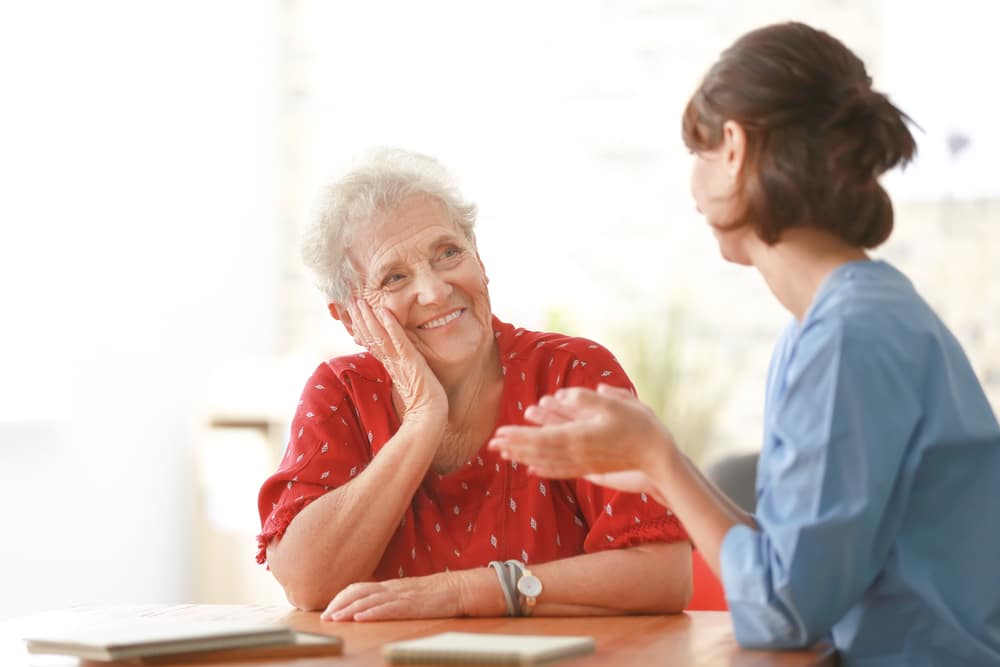 Young woman talking to smiling older woman