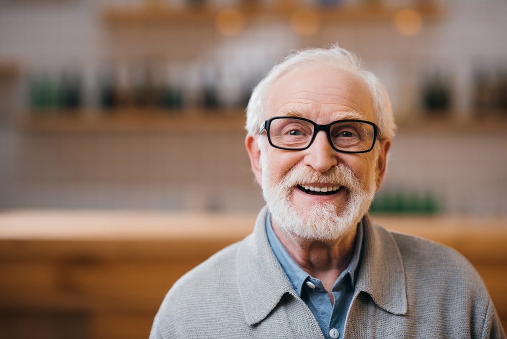 Smiling senior man wearing glasses indoors