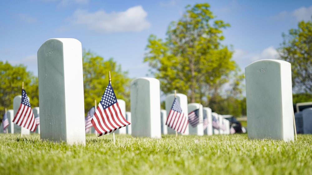Gravestones and American flags in US National Cemetery