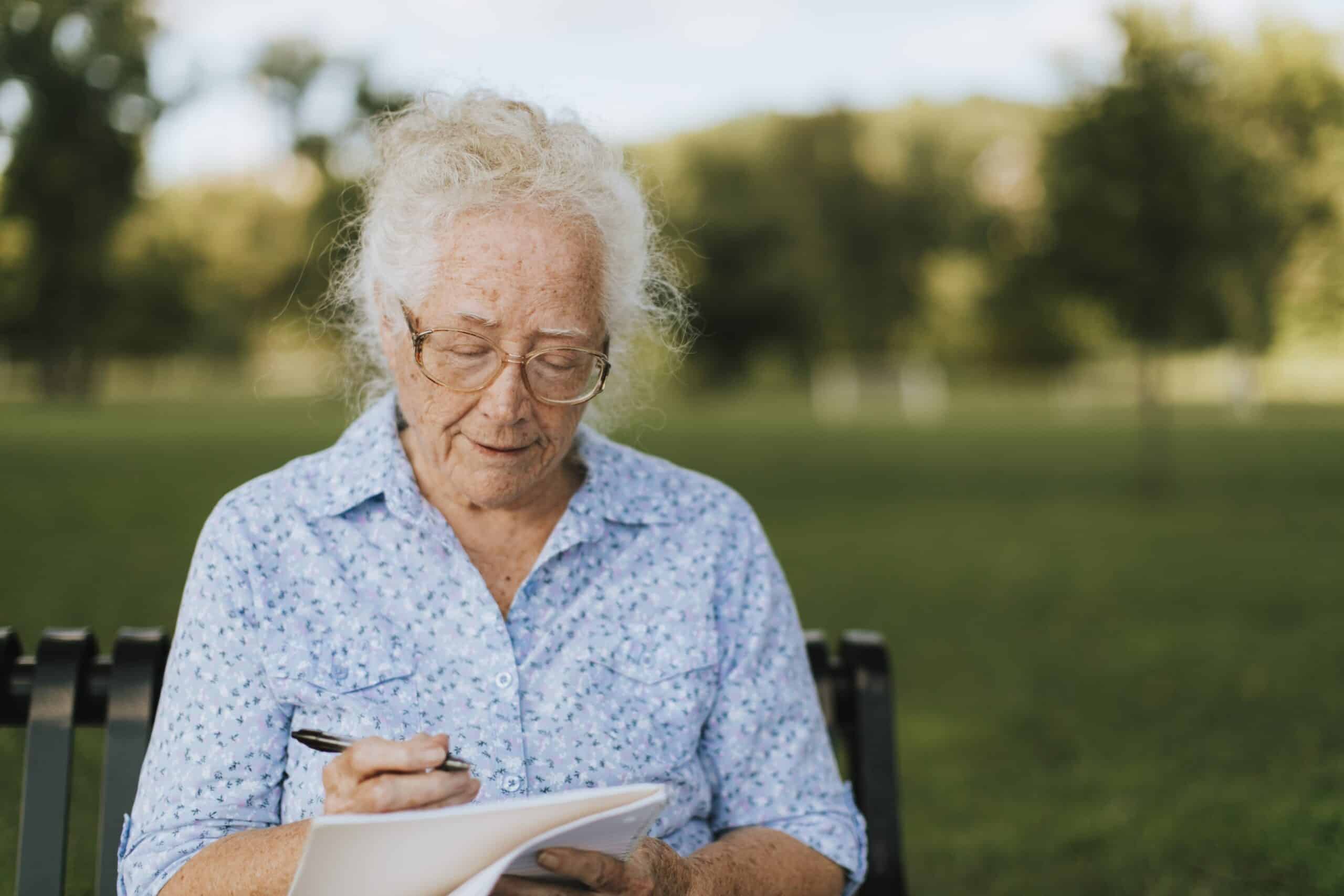 Senior woman journaling outside